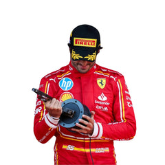 2024 Carlos Sainz Jr Monaco GP HP F1 Racing Suit - Bestracewear, standing on the Monaco Grand Prix podium, smiling as he raises the sleek, silver third-place trophy high above his head, celebrating his achievement under the Monte Carlo sky.