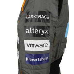 Zoomed-in look at Lando Norris’s 2023 suit featuring premium materials, high-contrast stitching, and detailed sponsor elements.Bestracewear