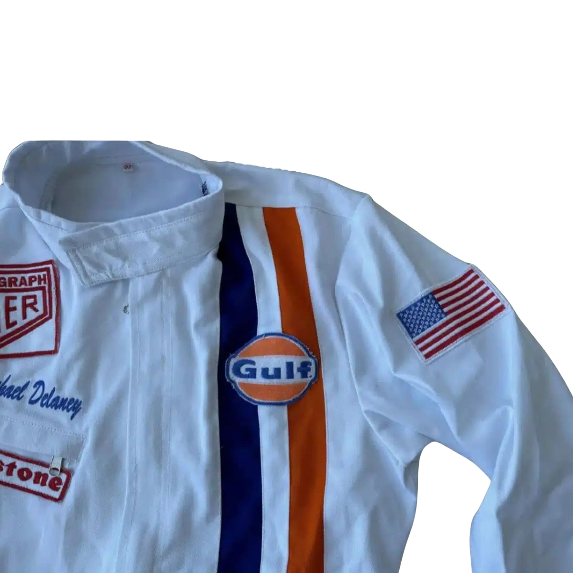 Close-up of the Gulf and Heuer logo patches, stitching detail, and authentic period-correct fabric from the 1971 Le Mans suit worn by Steve McQueen. BestRacewear