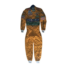 Front view of Michael Schumacher's 1992 F1 racing suit featuring deep green with yellow accents, signature Benetton sponsorship, and classic zip-front design-Bestracewear