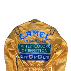 Back side of the 1992 Formula 1 suit worn by Michael Schumacher, showcasing era-specific sponsor logos and reinforced fabric seams for safety.Bestracewear