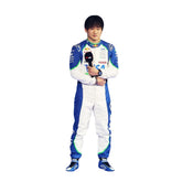 Front view of Yuki Tsunoda's 2025 F1 racing suit in white with blue side panels and green accents around the shoulders and collar, featuring sponsor logos.