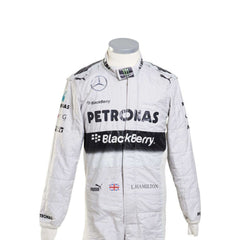 Close-up of Lewis Hamilton’s 2014 racing suit showing intricate stitching, sponsor branding, and iconic white-teal color scheme used throughout the championship.Bestracewear
