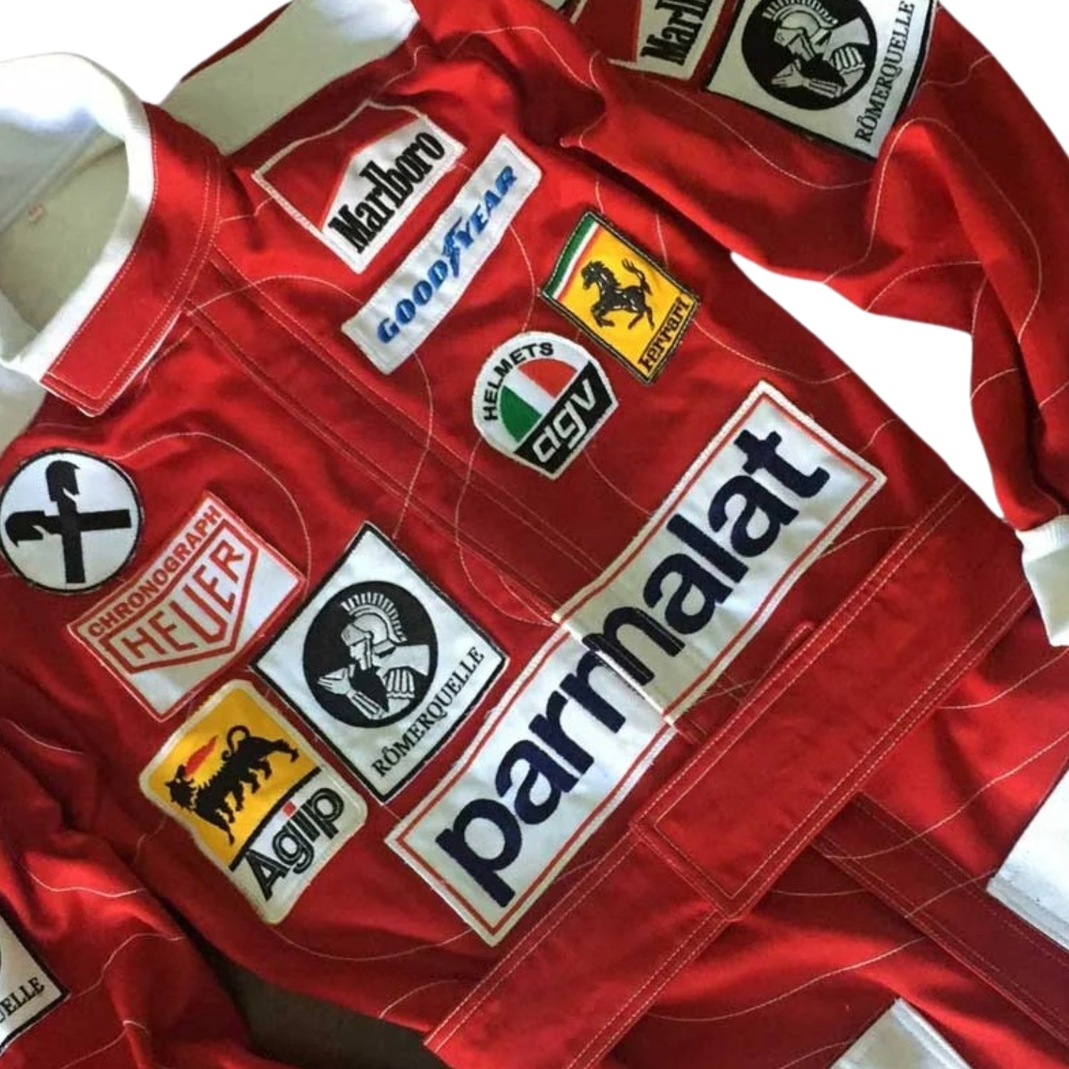 Close-up of Niki Lauda’s 1976 f1 racing suit detailing, capturing the fine craftsmanship of Ferrari’s design and the sponsor logos, a testament to his legendary comeback.Bestracewear